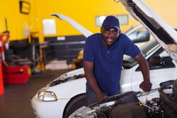 male african car mechanic inside workshop