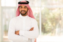 smiling arabian man with arms crossed
