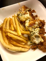 Hot and spicy chicken parma and frenchfries with cheese.