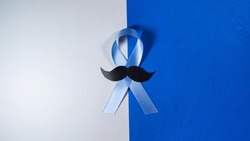 November Prostate Cancer Awareness month. Blue Ribbon with mustache for supporting people living and illness. Healthcare, International men, Father and World cancer day concept.
