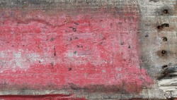 Discoloured scratched rustic faded red wood plank texture