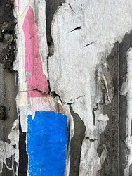 Abstract torn street poster bits on  worn urban wall background