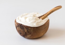 Greek yogurt in a wooden bowl. Healthy breakfast.Homemade Fatty Dairy product, sour cream, mayonnaise.