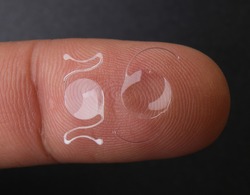 photo of two types of intra ocular lens on finger tip