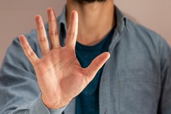 young man makes five points with his fingers