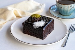 Chocolate moist cake. Wet cake in a plate. Bakery products. Close-up.
