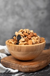 Mixed raw nuts. Special mixed nuts in bowl. Hazelnut, almond, cashew, pistachio, dried blueberry. Superfood. Vegetarian food concept. healthy snacks. Close up