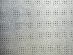 Perforated metal surface. Gradient aluminum background. Patterns on metal.