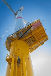 Offshore wind turbine technician climbing 
