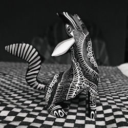 An Alebrije, a traditional mexican handcraft of fantastic animals with vivid and crazy colors. A colorful wolf piece of art. BLack and white