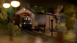 Toy diesel railway engine at depot station. Scale model railway layout with diesel locomotive.