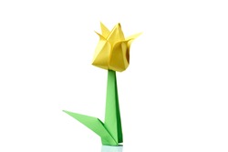 Yellow tulip origami flower. Traditional model of bulb and leaf. Simple origami crafting for beginners.