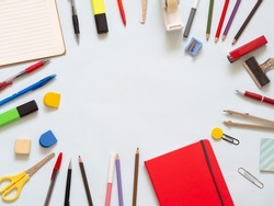 Back to school supplies in a circle. Stationery for study and journaling like colored pencils, notebook, highlighters, stapler, compass and adhesive tape. Teaching materials for junior school.