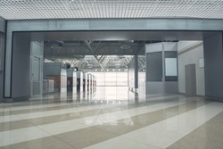 Interior of huge modern building inside with striped floor and different doors
