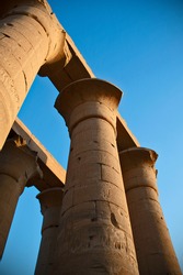 Giant Colums On A Blue Sky Background At Luxor Temple In Luxor, Egypt