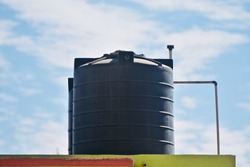 Black plastic water tanks of a house isolated unique photo