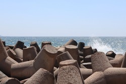 pebble beach with block and large stones to protection coastline from the storm ,breakwater in summer- Alexandria Egypt of Mediterranean sea
