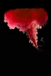 Frozen movement. Pink plume of smoke on a black background. Explosion simulation. Abstract, blurred background. Photo