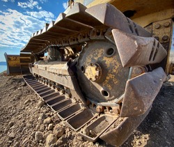 Closeup of old yellow bulldozer treads