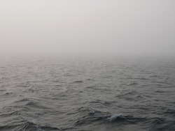 gray fog over gray surface of arctic ocean water