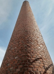 very tall brick chimney of an old sawmill