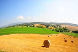Toscana landscape of the wheat field with hay bales