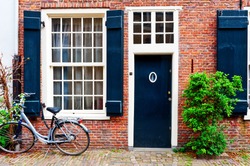 Bike in Front of a Brick Facade of the Old Dutch House