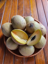 Sawo fruit in the wooden plate. Sawo is one of local Indonesian fruit
