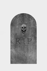 Decorated, oval granite tombstone on white background with engraved R.I.P. text and skull