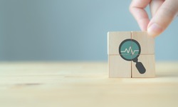 Annual medical health check up healthcare concept. Digital health check. Medical or health insurrance business. Hand puts the wooden cubes with health check up  icon on grey background and copy space.