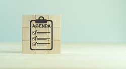Agenda meeting appointment activity information concept. List of meeting activities in the order to be taken up, beginning with the call to order, ending with adjournment. Agenda word on wooden cubes.