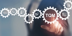 Total quality management (TQM) concept. Touching on smart screen with TQM text on smart background. Management approach to long-term success through customer satisfaction and sustainability.