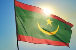 Mauritania flag waving on the wind in front of sun