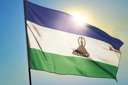 Lesotho flag waving on the wind in front of sun