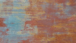 Old rusty iron texture with different layers of cracked paint. Abstract metal shabby background with copy space