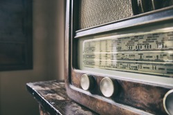 Obsolete radio in wooden case. Horizontal indoors shot