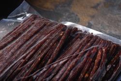 Smoked Pork Sticks in Vacuum Packing. Snacks for Beer close-up. Ready Food. Finished products