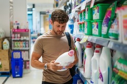 Male shopper buying laundry detergent
