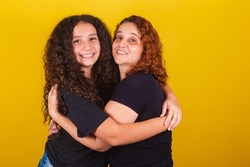 Grandmother and niece, Brazilian, Latin American, curls, afro hair, curly, smiling, hugging, family photo, beautiful. Mother's Day, Fraternity, Love.