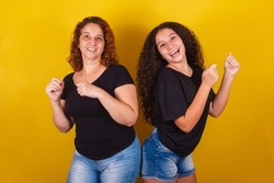 Grandmother and niece, Brazilian caucasian,  curly, dancing, happy, playing, dancing, family photo, beautiful. Mother's Day, Fraternity, Love.