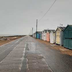 Felixstowe beach promenade with wooden beach huts during rainy cloudy May day in Felixstowe, Suffolk, East Anglia, England, united Kingdom, Europe 