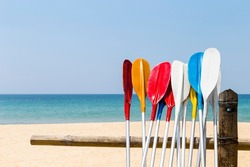 Colorful oars with beach background, water sport, holiday activity at the beach, summer outdoor day light