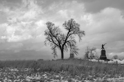 A black and white photo of a solemn winter scene on the Gettysburg National Military Park on the field of Pickett's Charge where union and confederate soldiers battled in July of 1863. 