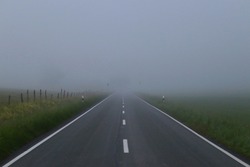 Country road lies in the fog