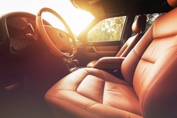 Premium car interior, brown leather at sunset