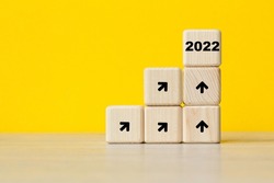 2022 year. interest growth trend. Cubes on a yellow background. Symbolizes growth. Business concept. copy space.