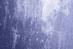 Grunge concrete grainy texture. Very peri color of the year 2022 violet blue abstract background. Cement wall close up.