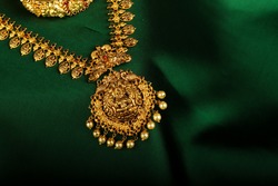 Amazing Antique Gold Jewelry placed on green silk cloth picture.