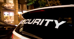 Security vehicle patrolling city at night