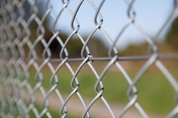 A selective focus shot of mesh fence